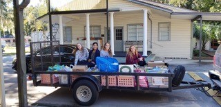 Alexis Magnano, Julia Peiris, Lindsey Blisko and Emily Rohan gather supplies they collected for area refugee students